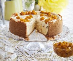 a cheesecake on a glass cake plate with a slice missing