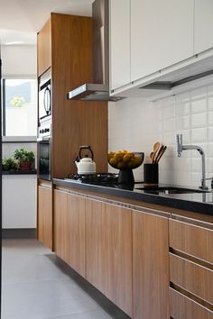 a kitchen with wooden cabinets and black counter tops