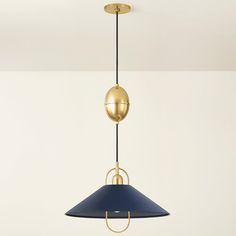 a blue and gold pendant light hanging from a ceiling in a room with white walls