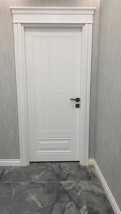 a white door in a room with grey walls