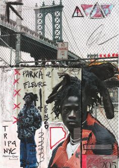 a man with dreadlocks standing in front of a fence covered in grafitti