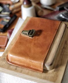 a brown leather case sitting on top of a wooden table