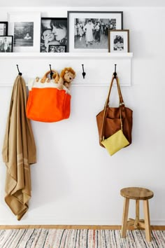 there are two bags hanging on the wall next to some pictures and a teddy bear