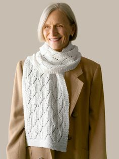 an older woman wearing a white knitted scarf