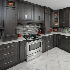 a kitchen with gray cabinets and stainless steel stove top oven in the center, surrounded by white tile flooring