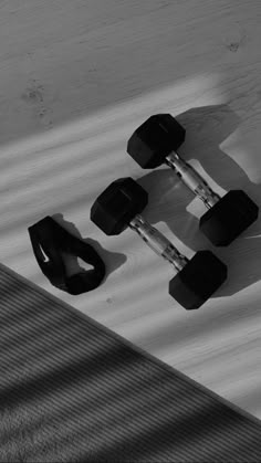 two black and white skateboards sitting on top of each other in the snow with wheels attached to them