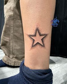 a woman's arm with a small star tattoo on the left side of her leg