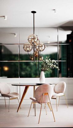 a dining room table with chairs and a chandelier