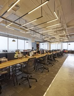 an empty office with many desks and chairs