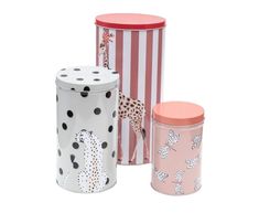 three tins with giraffes and zebra designs on them, one in pink, the other in white