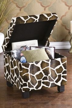 a giraffe print storage box with magazines in it