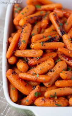 carrots in a white dish with parsley on top