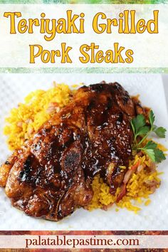 this teriyaki grilled pork steaks is served with yellow rice and cilantro