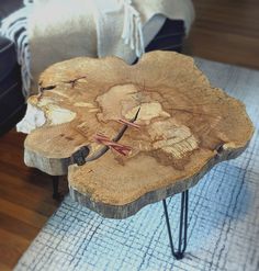 a wooden table with hairpin legs and a flower design on the top that has been cut in half