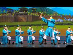 a group of people that are standing on a stage with some swords in their hands