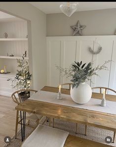 a dining room table with candles and flowers on it