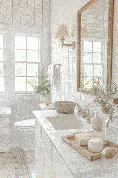 a white bathroom with two sinks and a mirror