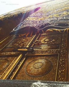 an ornate gold door with intricate designs on the outside and inside, is seen from below