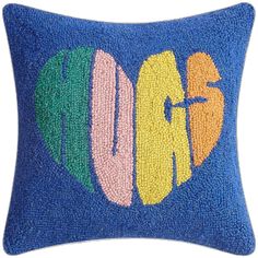 a blue pillow with the word love spelled in multicolored letters on it's side