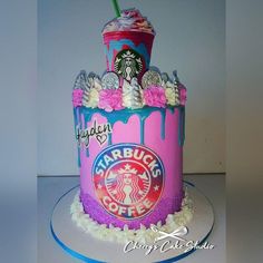 a pink and blue cake with starbucks coffee on top