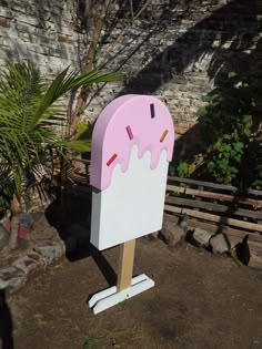 a pink and white ice cream cone shaped mailbox