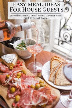 a table topped with lots of food and wine