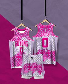 two pink and white basketball uniforms hanging on a hanger with the number 0 printed on it