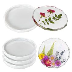 three glass plates with flowers painted on them