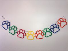 a multicolored dog paw banner hanging on a wall