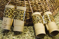 some toilet paper rolls are wrapped in leopard print and tied to twine with twine