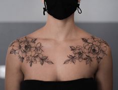 a woman wearing a face mask with flowers on her chest and shoulder tattoo design in black ink