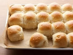 a box filled with rolls sitting on top of a wooden table