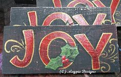 two wooden signs with the words joy and joy painted on them are sitting next to each other