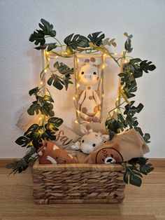 a basket filled with stuffed animals sitting on top of a wooden floor