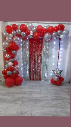 a red and silver balloon arch with balloons