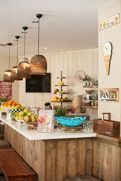 a kitchen filled with lots of counter top space next to a tv mounted on the wall