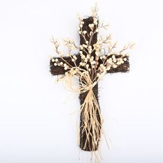 a cross decorated with flowers and branches on a white background for an easter or spring decoration