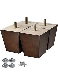 three square wooden boxes with screws and nuts on the top, one is made out of