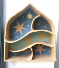 an artisticly designed shelf with stars painted on it