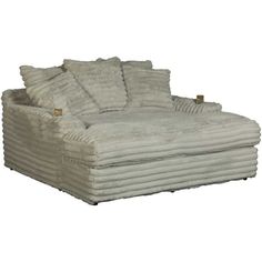 a large white couch with pillows on it's back and side ends, sitting in front of a white background