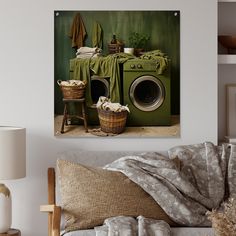 a living room with a green washer and clothes on the table next to it