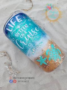 a can that is sitting in the sand with some writing on it's side