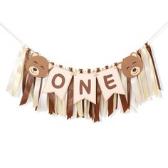 a teddy bear banner with the word one hanging from it's side on a string