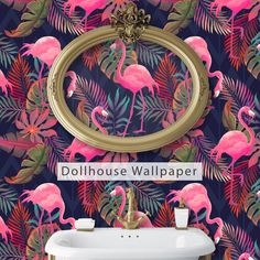 flamingos and palm leaves are featured in this bathroom wallpaper design with a gold framed mirror