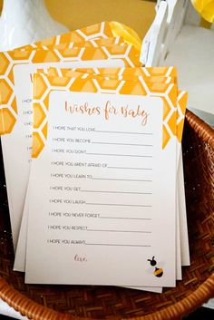 three baby wishes cards in a basket on a table