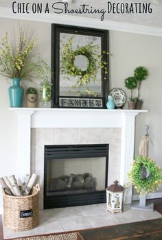 a living room with a fire place and various decorations on the mantel above it