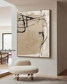 an abstract painting hangs on the wall in a living room