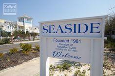 a welcome sign for seaside is shown in front of some houses and beachfronts