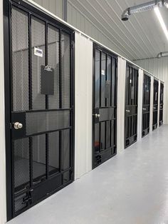 rows of black and white metal doors in a building