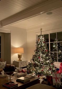 a living room with a christmas tree in the corner